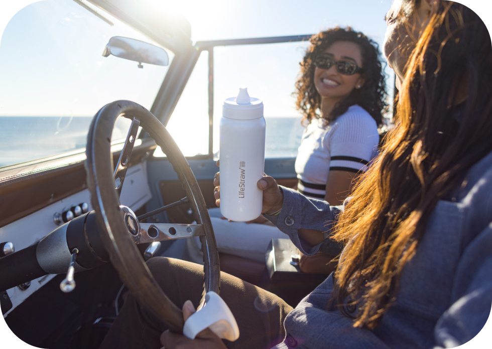 Biała butelka LifeStraw Go Steel 1L w&nbsp;podróży samochodem